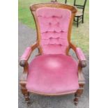 A Victorian mahogany showwood open armchair, with carved decoration and button back