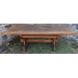An antique oak refectory dining table, fitted with a frieze drawer, raised on end supports united by