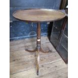 A 19th mahogany dish top tripod table, raised on turner column terminating with three out swept