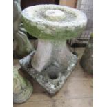 A stone garden bird bath