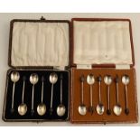 Two cased sets of hallmarked silver coffee bean tea spoons, together with a cased set of six