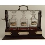 A wooden and EPNS mounted tantalus, with three square glass decanters, together with three