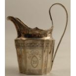 A Georgian Irish silver cream jug, with engraved decoration to the shaped body, weight 6oz