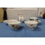 An early 19th century porcelain sparrow beak jug, together with two tea bowls and a saucer decorated