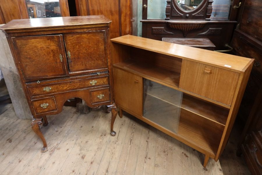 A retro set of glazed shelves, width 48ins, height 37.5ins together with a walnut cabinet, raised on