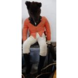 A plush toy fox, dressed in hunting pink, jodphurs and boots together with another toy fox