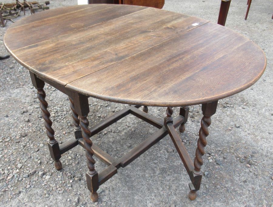 An oak gate leg table, with barley twist legs, height 30ins, width 38ins