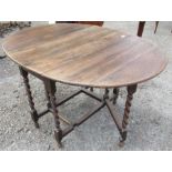 An oak gate leg table, with barley twist legs, height 30ins, width 38ins