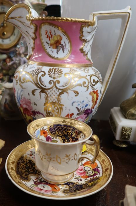 A 19th century English porcelain jug, together with a cup and saucer, all decorated with flowers