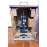 An oak cased Busch monocular microscope, numbered12548