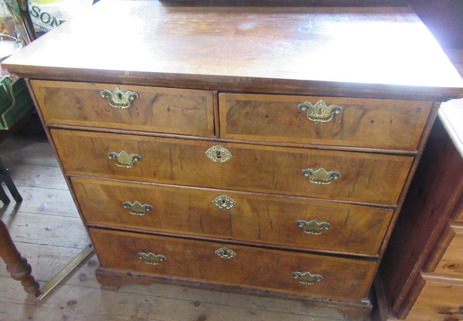 A 18th century design walnut chest of drawers, having two short drawers over three long drawers,