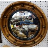 A circular gilt framed convex mirror