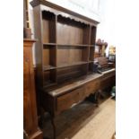 An Antique oak dresser, with a boarded back plate rack, width 59ins, height 82ins