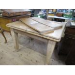 An extending pine dining table, width 48ins, max. length, 56ins