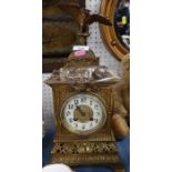 A brass cased mantel clock, with eagle finial