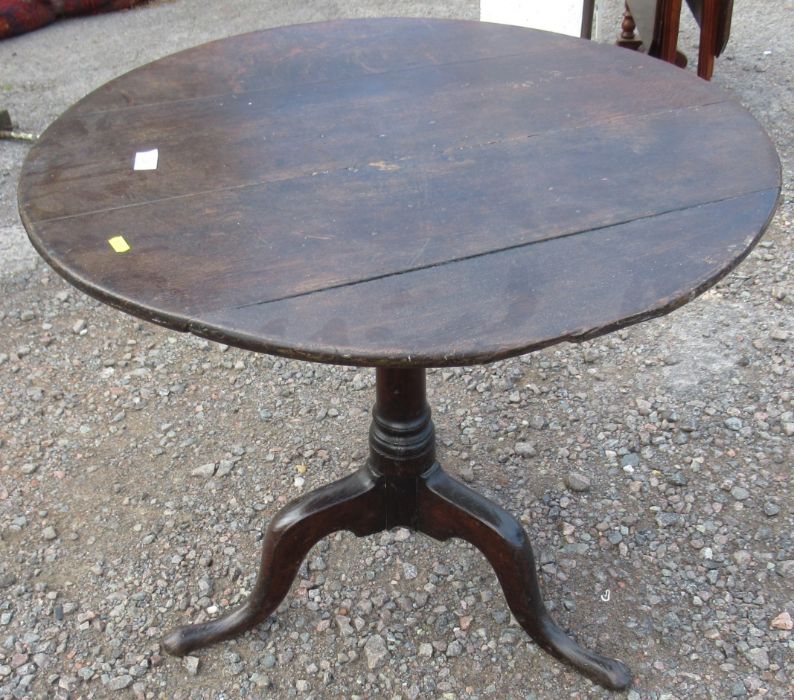 An 19th century oak tripod table, diameter 30.5ins, height 26ins