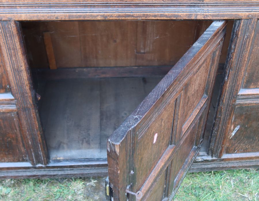 An antique oak court cupboard, fitted with two cupboards to the upper section, and a central - Image 4 of 5