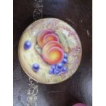 A Royal Worcester dish, decorated with fruit, signed A J Wade, diameter 4.5ins