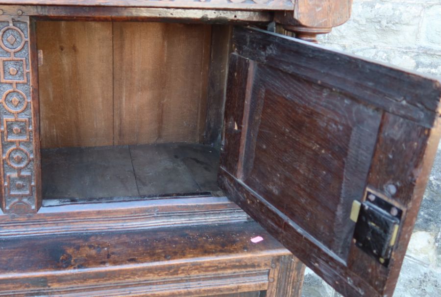 An antique oak court cupboard, fitted with two cupboards to the upper section, and a central - Image 3 of 5