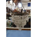A three tier light fitting with clear droppers