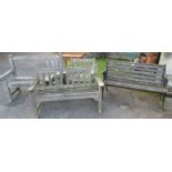A collection of garden benches to include one with wrought iron ends