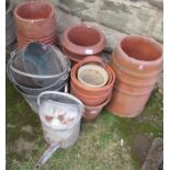 A collection of garden pots and a cast iron boot scrape