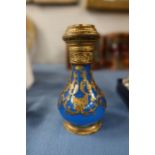 A blue glass baluster shaped scent bottle, with gilt overlay scrolls, the gilt metal hinged top