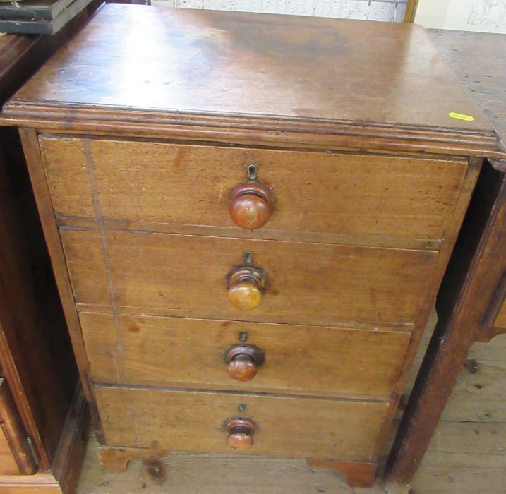 An Antique mahogany bedside chest of four drawers