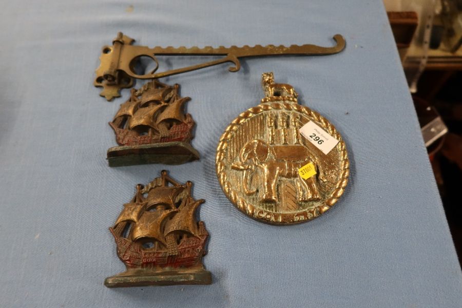 A Coventry brass boat plaque, embossed with an elephant and a castle, together with a pair of ship