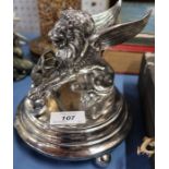 A silver plated table ornament, mounted with a winged lion and a bud holder, af