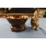 A cloisonne bowl, on a wooden stand, together with a clay model of a kneeling figure