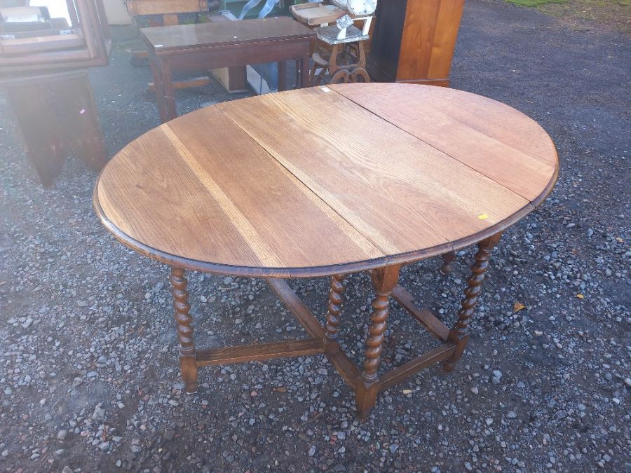 An oak gate leg table, with barley twist legs