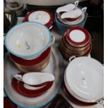 A collection of Royal Worcester dinnerware, with red border together with a platter and soup dishes