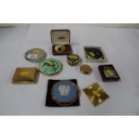 A collection of ladies compacts, to include Stratton, a lighter, horn brooch and a porcelain pill