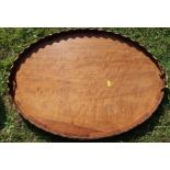 A mahogany oval gallery tray, with brass handles, 29ins x 20ins