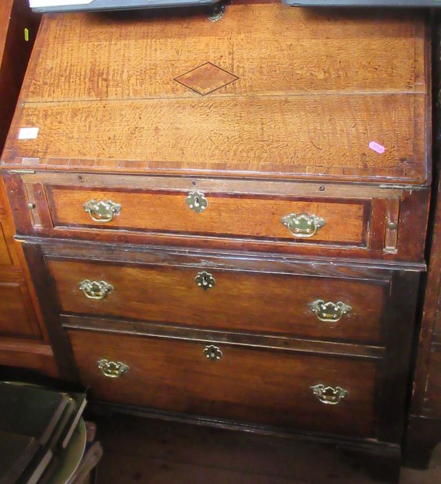 An Antique oak bureau, with lozenge decoration, width 31ins