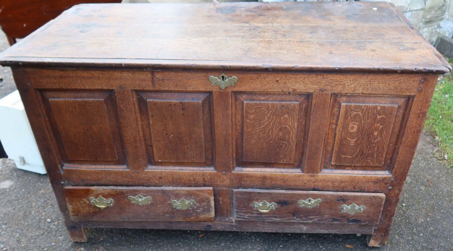 An Antique oak mule chest, with four panels to the front over two drawers, 50.5ins x 25ins, height