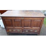 An Antique oak mule chest, with four panels to the front over two drawers, 50.5ins x 25ins, height