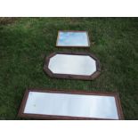 An oak framed mirror, 39ins x 9.5ins together with two others