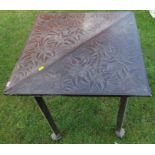 An oak carved top table, with drop flap, changing from a triangular to a square shape, 23ins x