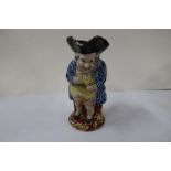 A 19th century Staffordshire toby jug, of a standing man in blue coat, height 8.25ins