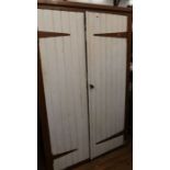 A painted pine cupboard, the pair of doors revealing shelves, height 73ins, width 48ins, depth