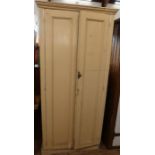 A painted pine cupboard, the pair of doors revealing shelves, height 75ins, width 35ins, depth