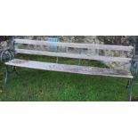 A garden bench, with wrought iron frame