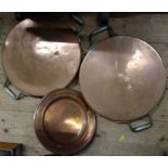 Two copper sauce pan lids and a plate