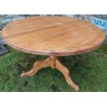 A pine circular kitchen table, diameter 48ins, height 30ins