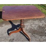 A 19th century rectangular tilt top table, raised on a turned column and three outswept supports,