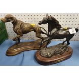 A metal model of a dog, together with another of a horse