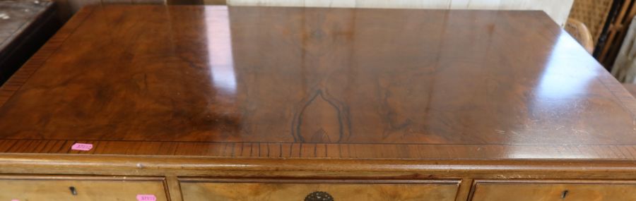 A walnut veneered chest, consisting of a bank of two drawers flanked by a drawer, over four long - Image 2 of 2