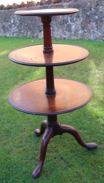 A 19th century mahogany three tier dumb waiter, raised on a tripod base, height 43ins, diameter of